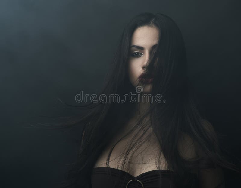 Mysterious portrait of a girl in dark fog