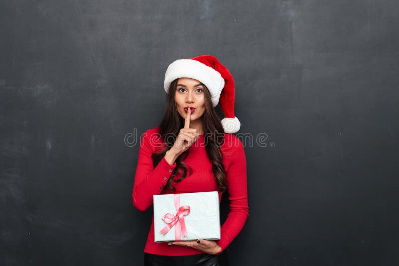 Mystery brunette woman in red blouse and christmas hat