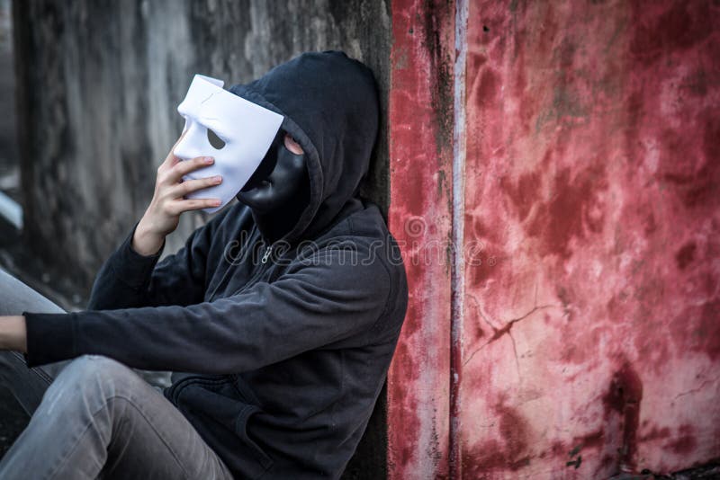 Mystery man taking of the mask showing another mask under it royalty free stock photos Mystery man taking of the mask showing another mask under it royalty free stock photos