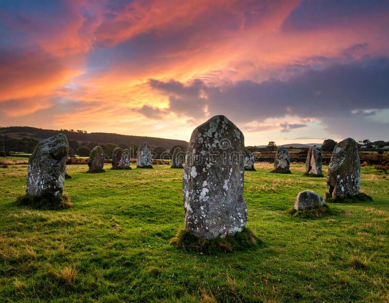 A Peaceful, Ancient Stone Circle in the Middle of a Grassy Field Under a Dramatic Sky stock illustration
