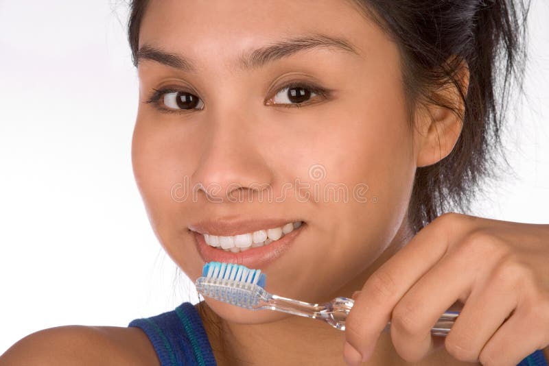 Teenager girl brushes her teeth. She is already adult woman and can handle her dental hygiene routine. Teenager girl brushes her teeth. She is already adult woman and can handle her dental hygiene routine