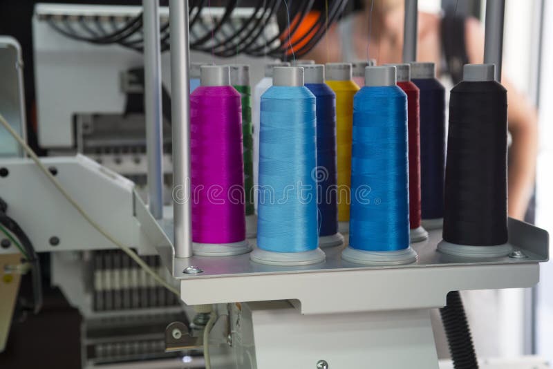 Embroidery machine with spools of color threads. Embroidery machine with spools of color threads