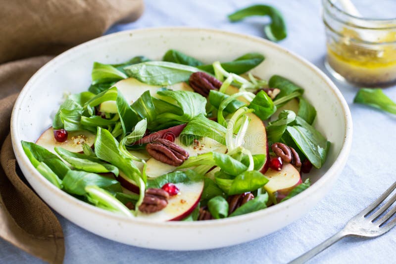 MÃ¢che with Apple, Pomegranate and Pecan salad by vinaigrette. MÃ¢che with Apple, Pomegranate and Pecan salad by vinaigrette