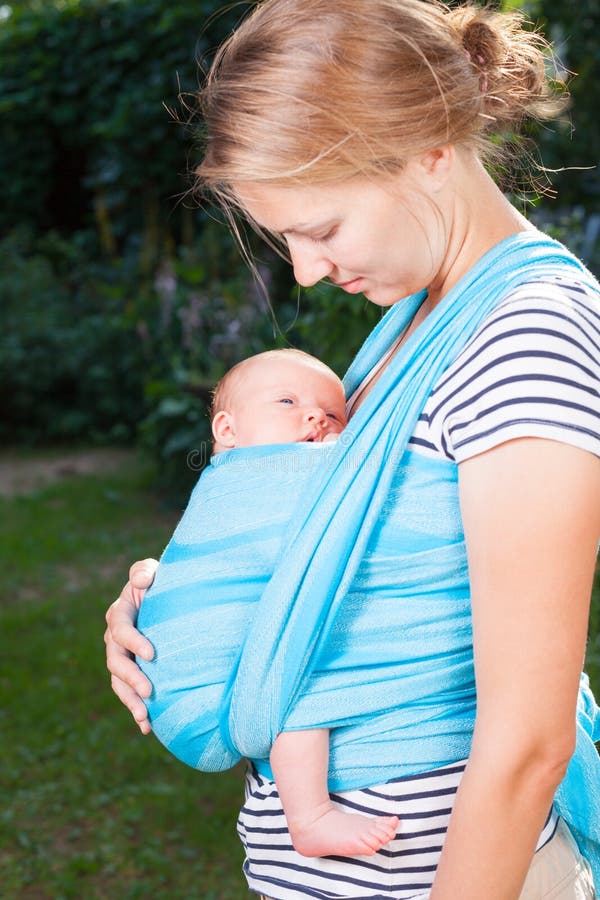 Mãe com o bebê recém-nascido no estilingue imagens de stock Mãe com o bebê recém-nascido no estilingue imagens de stock