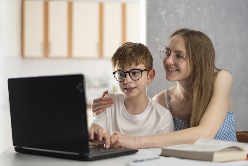 Mother and son are doing homework on the computer. Sister helps her brother with lessons. Tutor explains topic to child. Mother and son are doing homework on the computer. Sister helps her brother with lessons. Tutor explains topic to child.