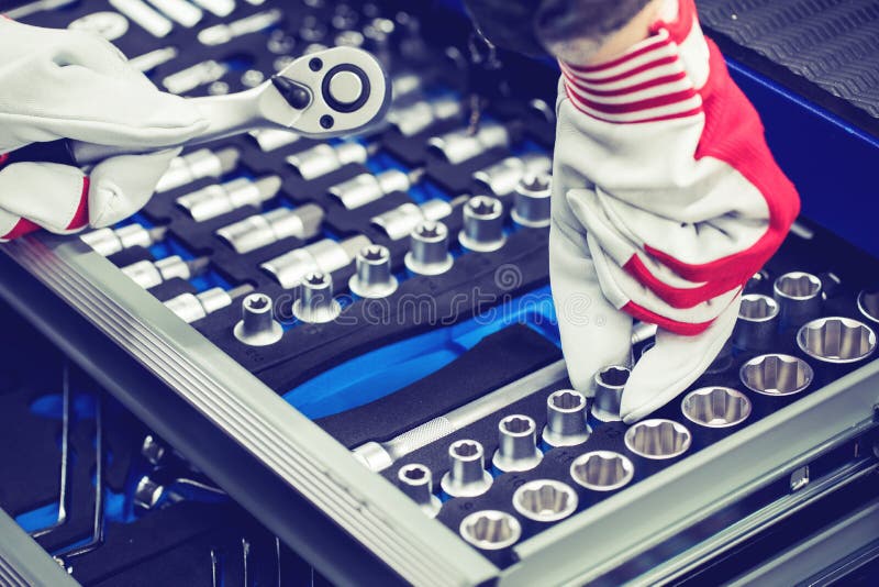 hand of auto mechanic picking spanner out of tools drawer. closeup. hand of auto mechanic picking spanner out of tools drawer. closeup