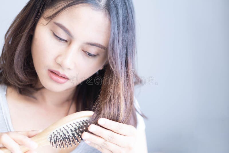 Mão-de-mão com pente com problemas graves de perda de cabelo para o xampu de saúde e o conceito de produto de beleza, foco seleti foto de stock Mão-de-mão com pente com problemas graves de perda de cabelo para o xampu de saúde e o conceito de produto de beleza, foco seleti foto de stock