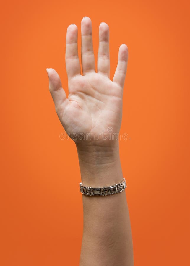 Raised Female Hand Isolated on Orange. Raised Female Hand Isolated on Orange