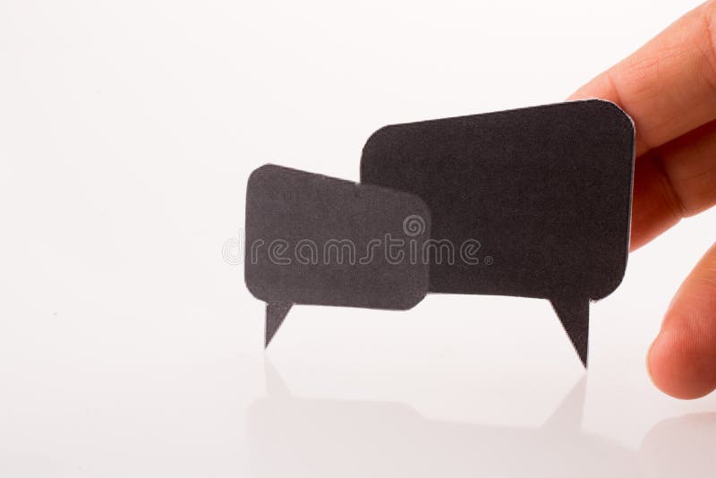 Mão a segurar caixas de diálogo imagens de stock