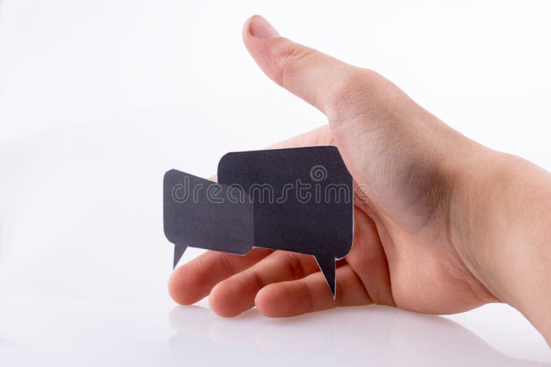 Mão a segurar caixas de diálogo fotografia de stock