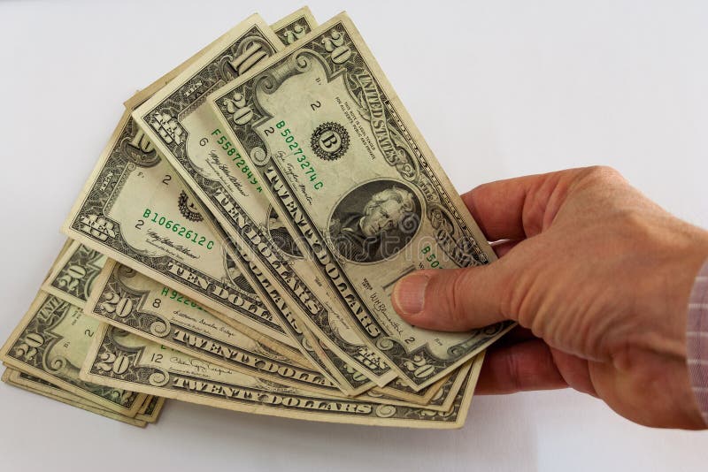 Mão que guarda um fã dos dólares fotos de stock royalty free