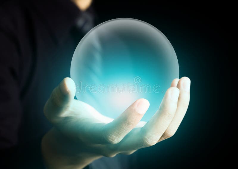 Hand holding glowing crystal ball. Hand holding glowing crystal ball