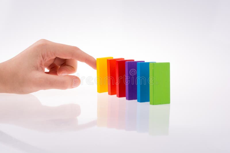 Mão a brincar com dominós coloridos imagem de stock royalty free