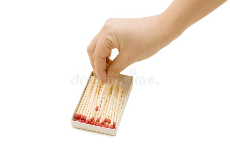 Hand takes out a match from a matchbox isolated over white. Hand takes out a match from a matchbox isolated over white