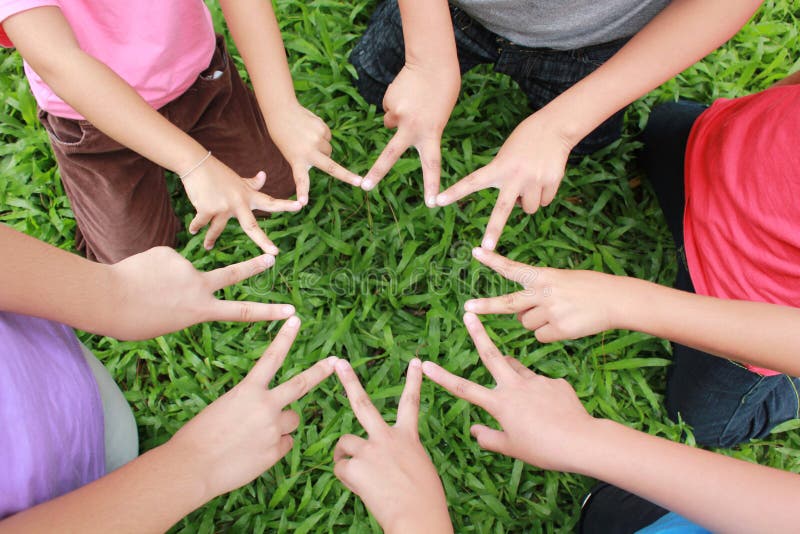 Children hands with green grass background. Children hands with green grass background.