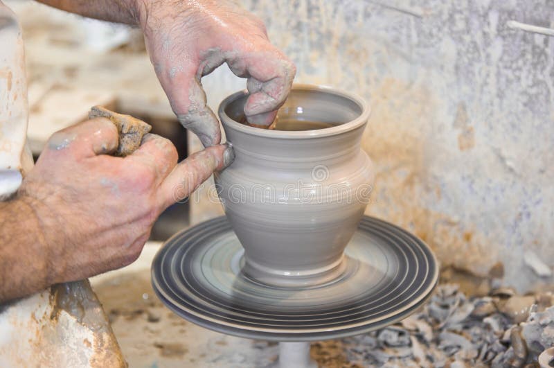 Potter hands and turning wheel. Potter hands and turning wheel