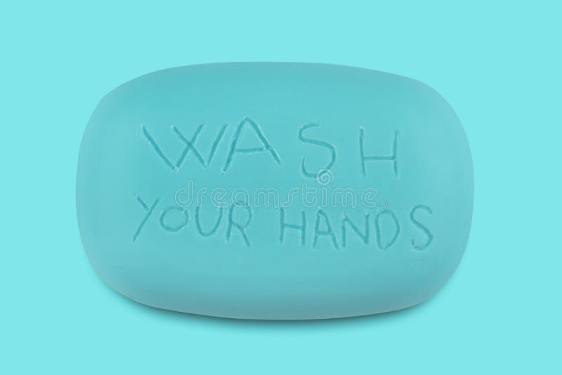 Top view of a blue soap bar with the words wash your hands scratched on it. Top view of a blue soap bar with the words wash your hands scratched on it