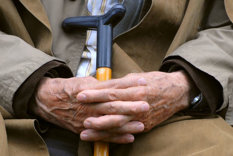 Man resting with walking stick. Man resting with walking stick