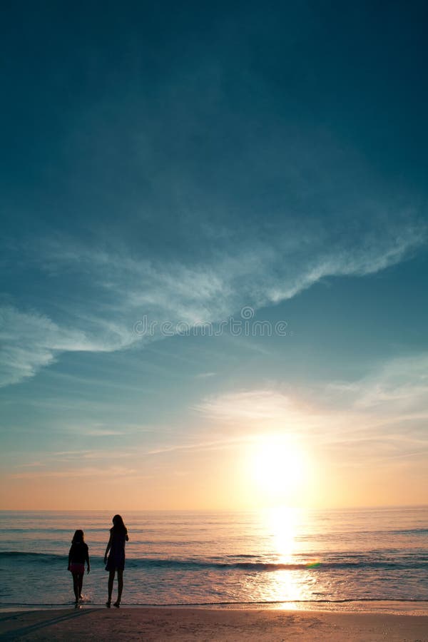 Mädchen auf schönem Strand während des Sonnenuntergangs.
