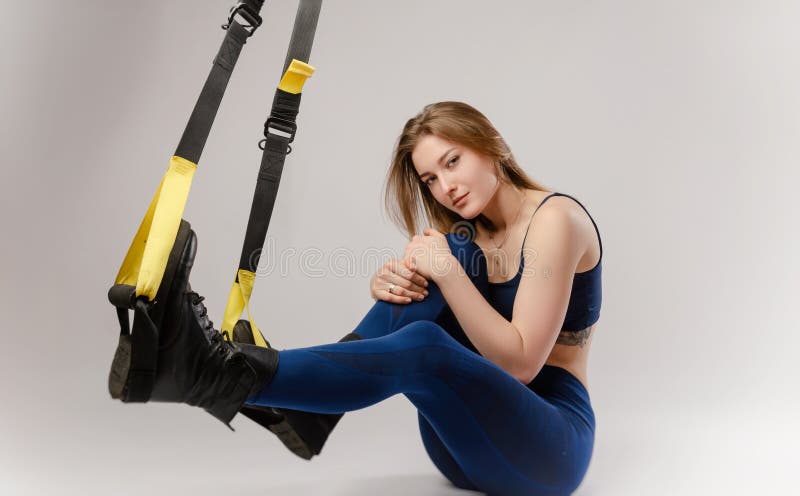 Mädchen auf weißem Hintergrund mit TRX-Schleifen lizenzfreies stockbild