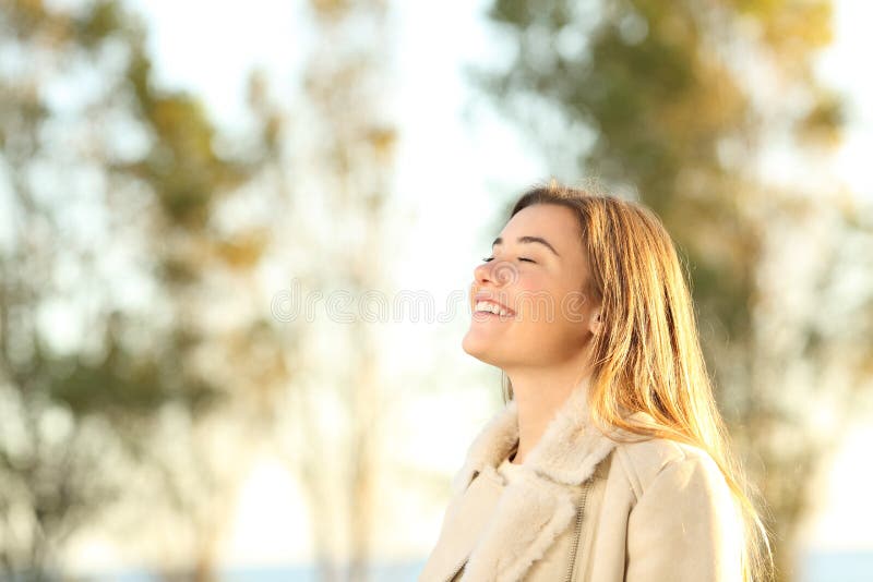 Portrait of a girl breathing fresh air wearing jacket at sunset. Portrait of a girl breathing fresh air wearing jacket at sunset