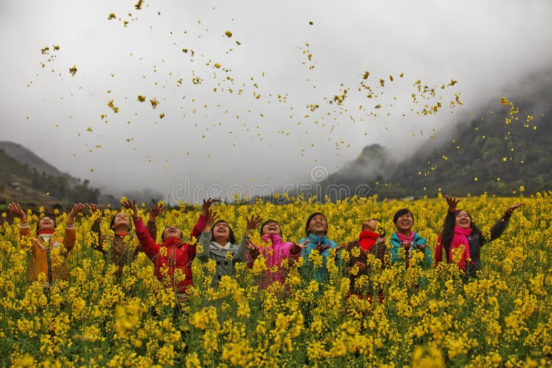 Ethnic minority girls in a field of canola at Quan Ba, Ha Giang province, Vietnam. Ha Giang is one of the six poorest provinces of Vietnam. Ha Giang is a famous tourist destination in Vietnam. Photo taken on: 03 May 2011. Ethnic minority girls in a field of canola at Quan Ba, Ha Giang province, Vietnam. Ha Giang is one of the six poorest provinces of Vietnam. Ha Giang is a famous tourist destination in Vietnam. Photo taken on: 03 May 2011