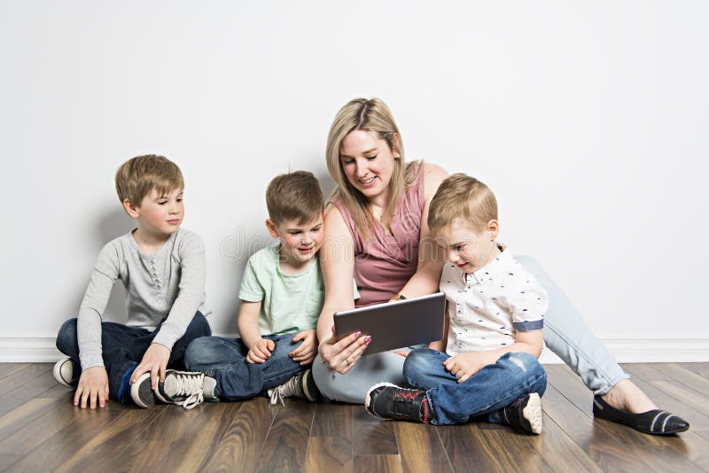 Sitzen Mädchen und ihre Mutter auf dem Boden, unter Verwendung einer digitalen Tablette