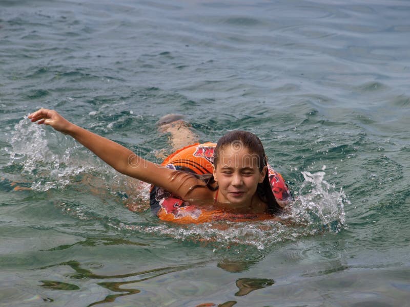 Mädchenschwimmen mit Herbewegungsring stockfoto Mädchenschwimmen mit Herbewegungsring stockfoto