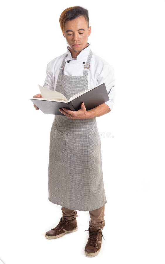 Männlicher Koch liest über Rezepte lizenzfreies stockbild
