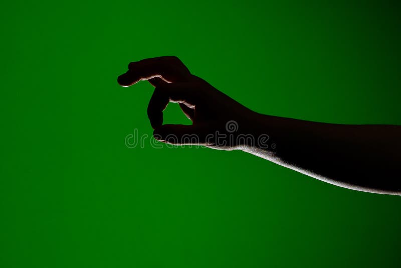 Mänsklig hand, vikt tillsammans för att ta lite litet, isolerat på en röd bakgrund royaltyfri foto Mänsklig hand, vikt tillsammans för att ta lite litet, isolerat på en röd bakgrund royaltyfri foto
