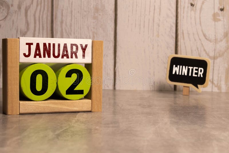 January 2nd.January 2 white wooden calendar on wood background.Copyspace for your text.Winter day. January 2nd.January 2 white wooden calendar on wood background.Copyspace for your text.Winter day.