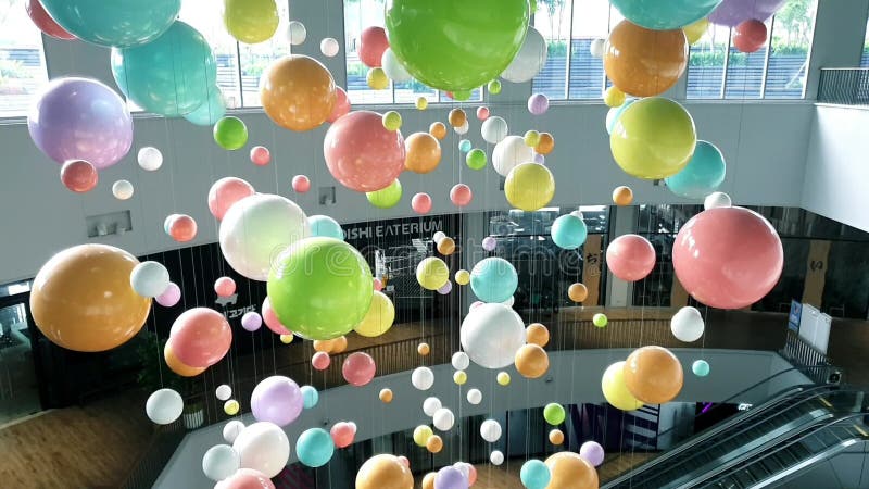 Många färgstarka ballonger som flyger högt i hallen