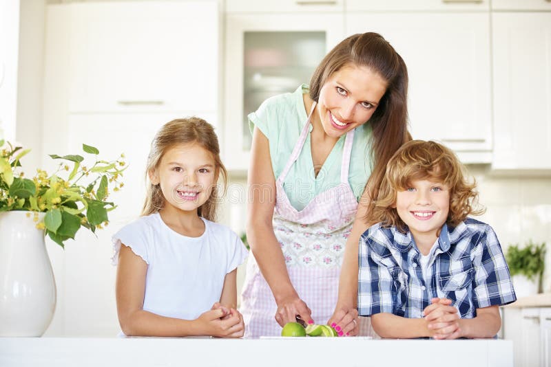 Mère et enfants coupant des fruits de chaux image libre de droits Mère et enfants coupant des fruits de chaux image libre de droits