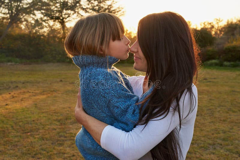 Mère fille et serrer dans la nature extérieure affection et ensemble pour se lier dans la cour. maman fille et embrasser images libres de droits