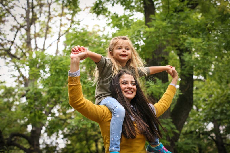 Mère portant son enfant sur l'épaule Sur le mouvement photos stock