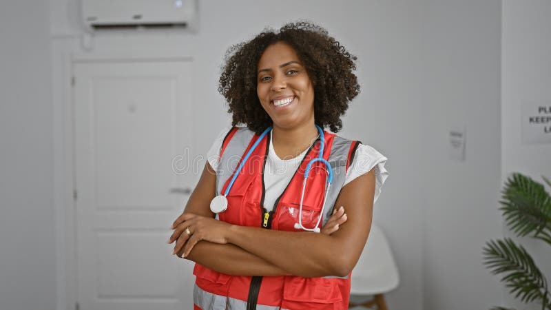 Médecin américain africain souriant dans le couloir de la clinique image libre de droits