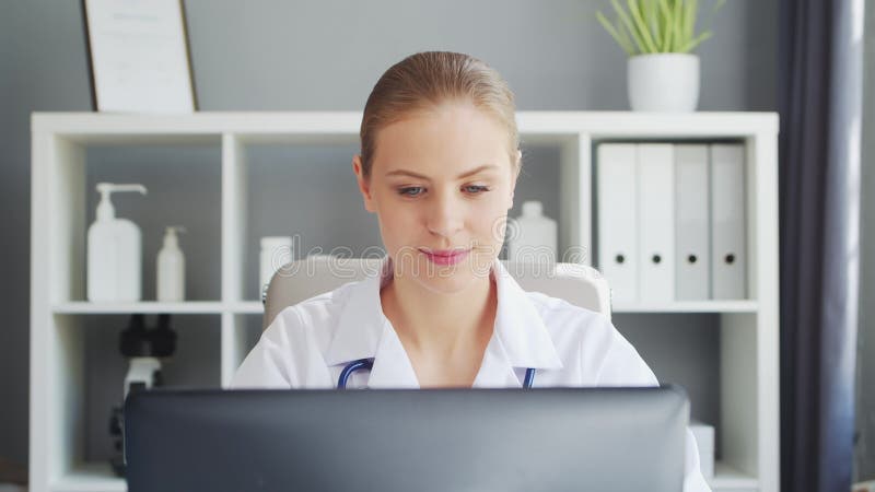 Médecin travaille au cabinet médical. femme en manteau blanc. lieu de travail d'une femme thérapeute professionnelle dans un hôpit banque de vidéos