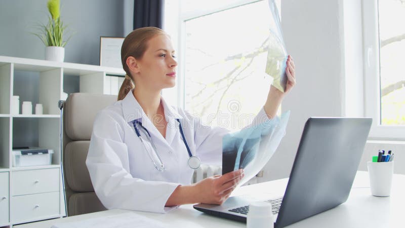 Médecin travaille au cabinet médical. femme en manteau blanc. lieu de travail d'une femme thérapeute professionnelle dans un hôpit banque de vidéos