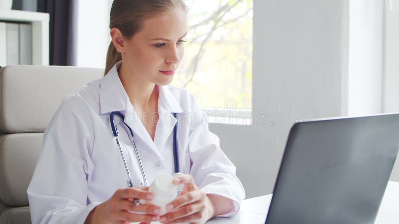 Médecin travaille au cabinet médical. femme en manteau blanc. lieu de travail d'une femme thérapeute professionnelle dans un hôpit banque de vidéos