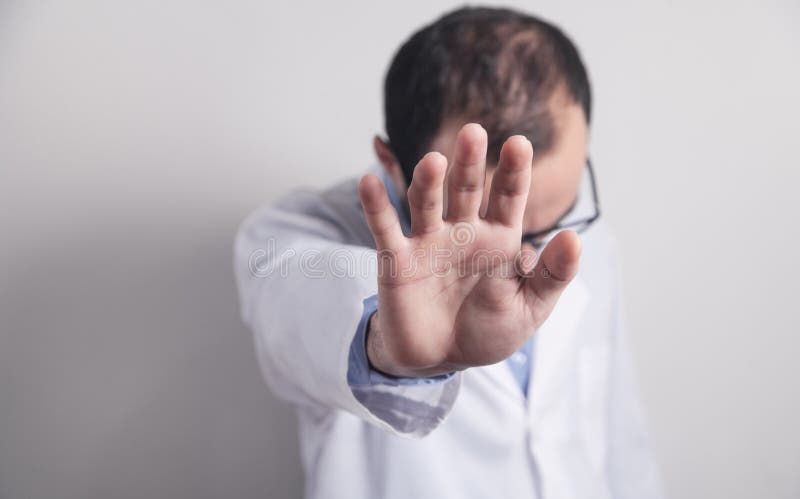Médico caucasiano com sinal de paragem foto de stock