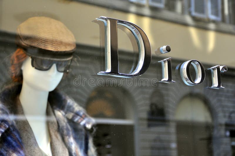 Beautiful woman mannequin head with a hat and eyeglasses in a shop . Christian Dior high quality boutique in Florence, Italy. Beautiful woman mannequin head with a hat and eyeglasses in a shop . Christian Dior high quality boutique in Florence, Italy.