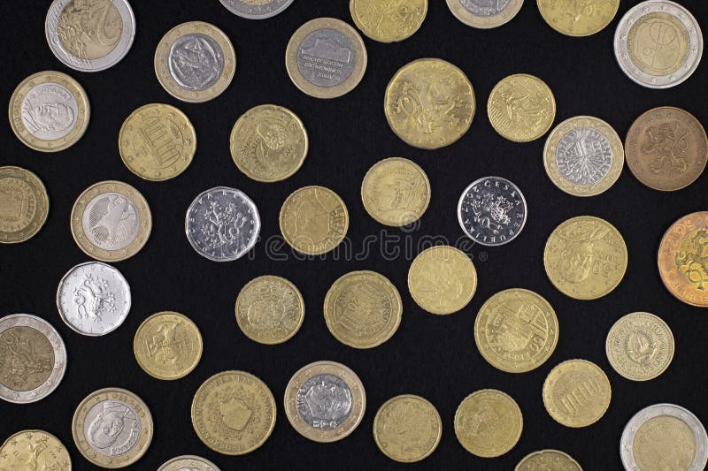 Pattern of European coins on a black cloth, top view, close-up. Pattern of European coins on a black cloth, top view, close-up.