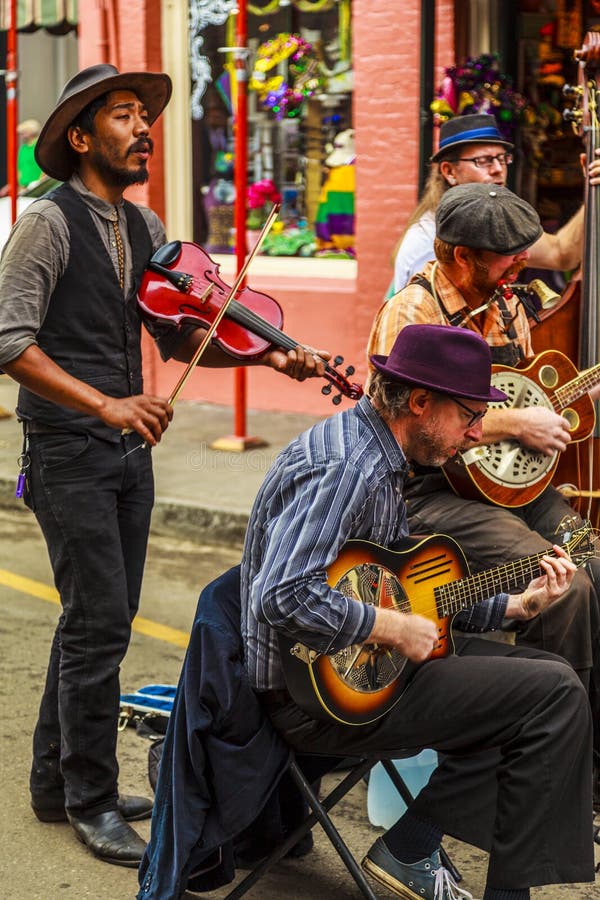 NEW ORLEANS, LOUISIANA USA- FEB 2 2016: An unidentified local jazz band performs in the New Orleans French Quarter on, to the delight of visitors in town. NEW ORLEANS, LOUISIANA USA- FEB 2 2016: An unidentified local jazz band performs in the New Orleans French Quarter on, to the delight of visitors in town