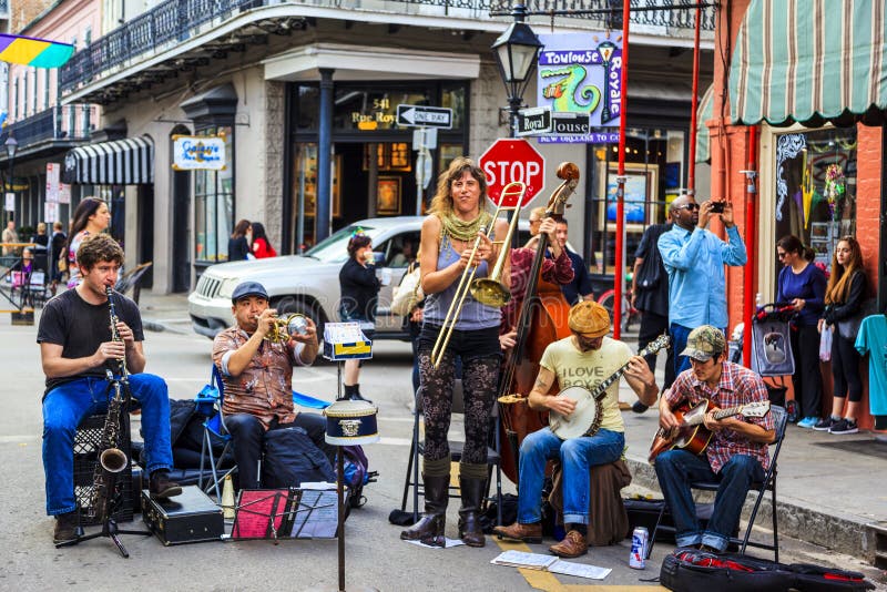 NEW ORLEANS, LOUISIANA USA- FEB 2 2016: An unidentified local jazz band performs in the New Orleans French Quarter on, to the delight of visitors in town. NEW ORLEANS, LOUISIANA USA- FEB 2 2016: An unidentified local jazz band performs in the New Orleans French Quarter on, to the delight of visitors in town