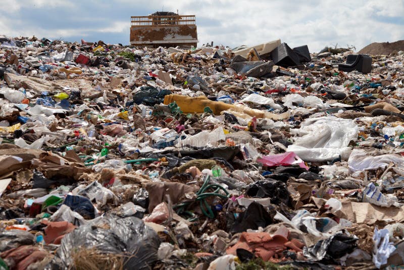 Truck managing garbage in a landfill site. Truck managing garbage in a landfill site