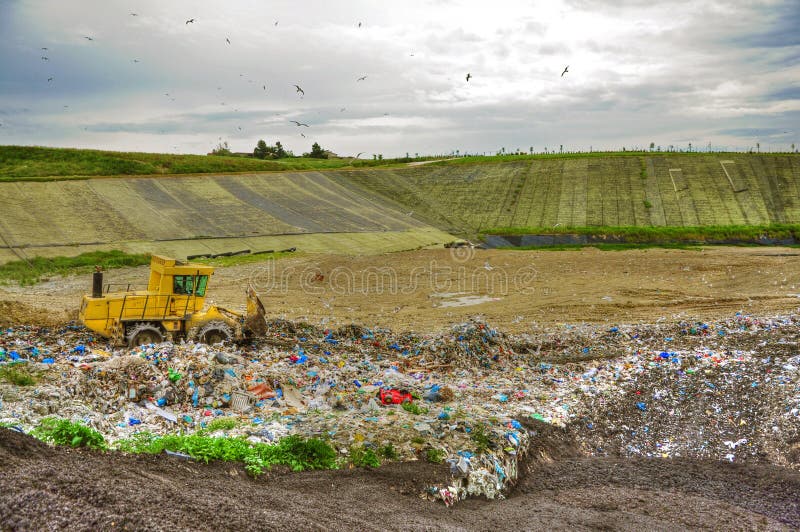 Machine working with garbage in landfill. Machine working with garbage in landfill