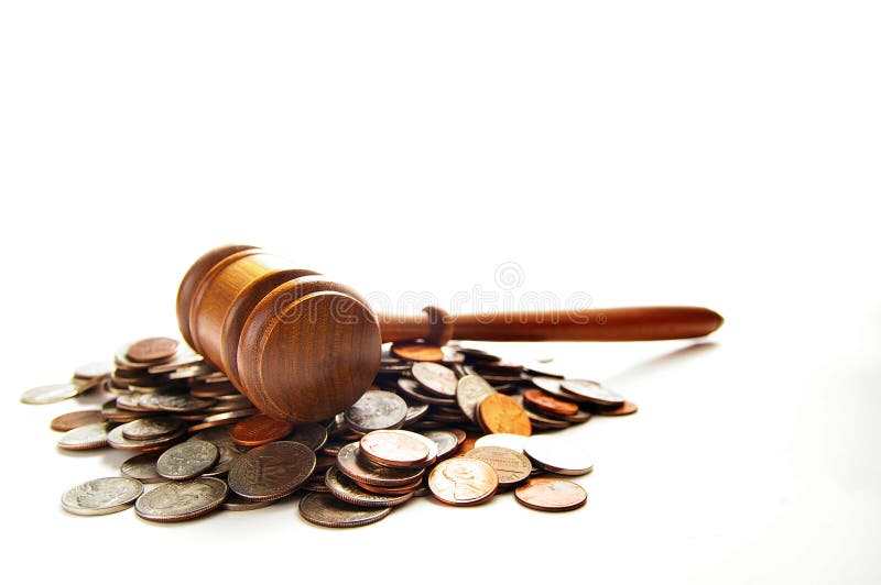 Judges law gavel on a pile of coins, over white. Judges law gavel on a pile of coins, over white