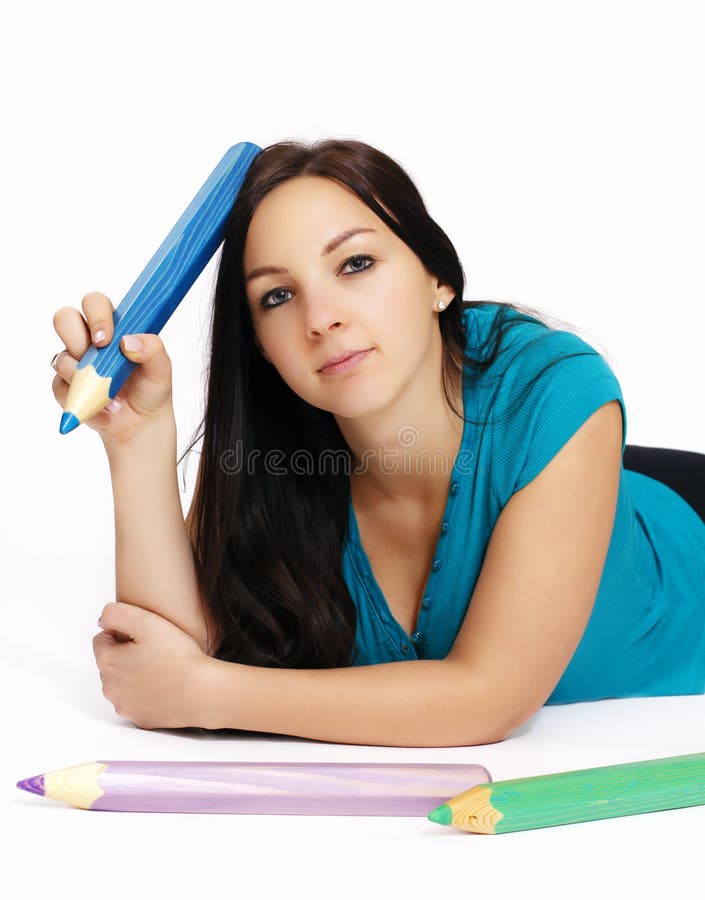 Smart young girl with big pencil lying on the floor. Smart young girl with big pencil lying on the floor