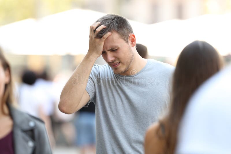 Portrait of a man suffering head ache walking on the street. Portrait of a man suffering head ache walking on the street