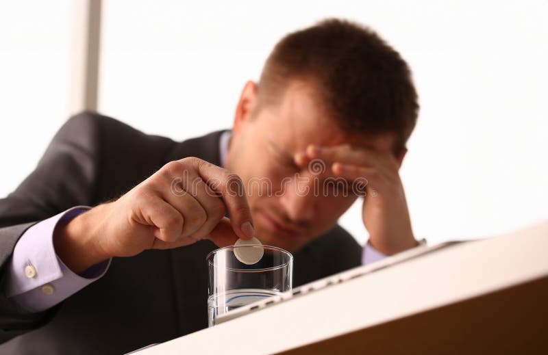 Adult male businessman hold tablet on glass water. On January 1 after celebrating the new year came to work while intoxicated closeup concept. Adult male businessman hold tablet on glass water. On January 1 after celebrating the new year came to work while intoxicated closeup concept